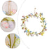 A close-up of a pastel Easter egg wreath with speckled eggs and a twine hanger, showing detailed craftsmanship.