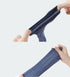 Hands demonstrating the stretch and elasticity of navy blue ankle socks against white background. Shows fabric quality with ribbed sections for comfort