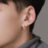 Double-band silver earring worn on ear, profile view