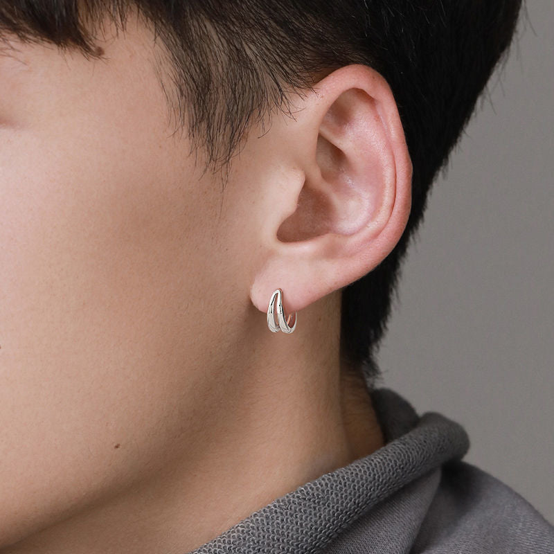 Double-band silver earring worn on ear, profile view