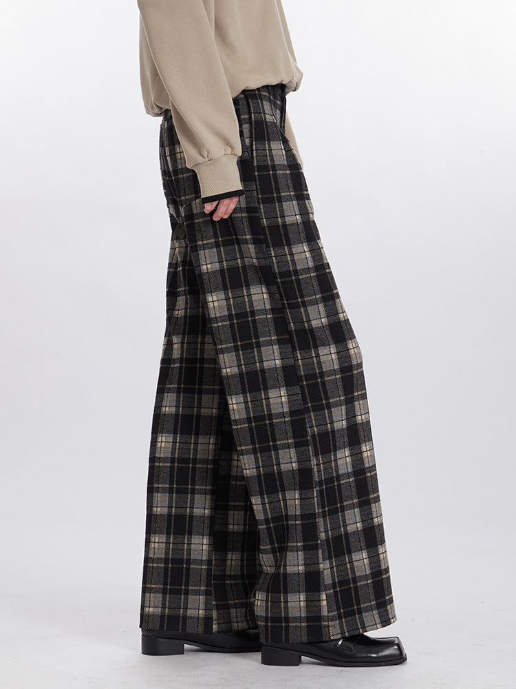 Detail view of wide-leg pants in gray and black plaid pattern