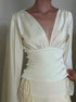 Elegant white satin V-neck top with ruched waist and long sleeves