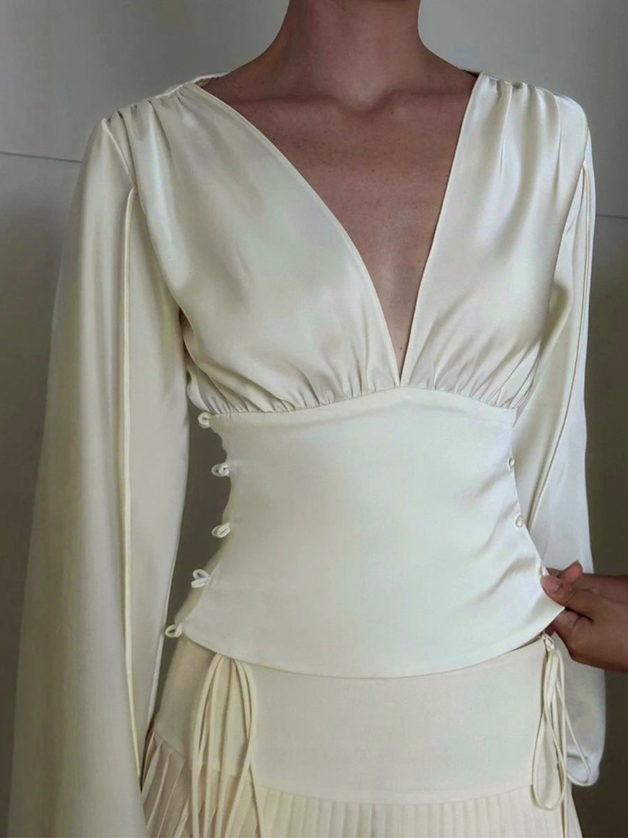 Elegant white satin V-neck top with ruched waist and long sleeves
