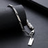 Silver chain bracelet with pearl accents and a rectangular tag charm, displayed on black textured surface. Sleek and stylish accessory.