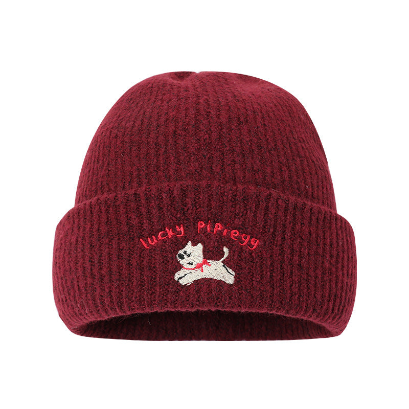 Burgundy winter beanie with embroidered jumping puppy logo and Lucky Pipiegg text