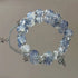 Light blue crystal beaded bracelet with silver star charms and cross pendant, featuring decorative spacers