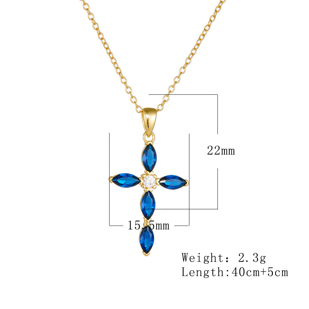 A gold sapphire cross pendant showing measurements of 22mm x 15.5mm with 40cm chain length and 2.3g weight