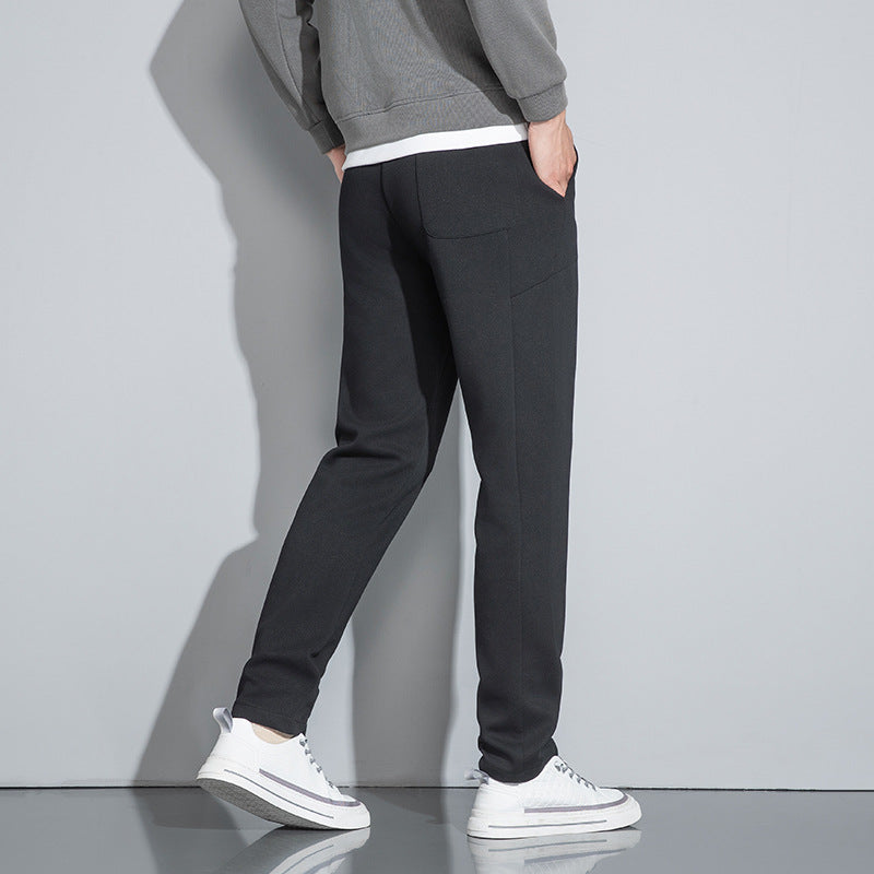 Close-up of pants showing white drawstring with black tips and side panel details