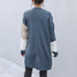 Back view of long colorblock cardigan showing slate blue body with beige and white striped sleeves