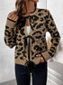 Close-up view of model in tan leopard cardigan with black trim, showing tie closure detail