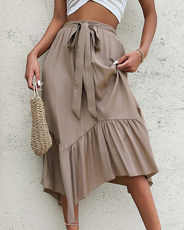Close-up of a khaki high-waisted midi skirt with a ruffle detail, highlighting its lightweight fabric and feminine drape.