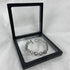 Silver chain bracelet displayed inside a transparent black jewelry box.