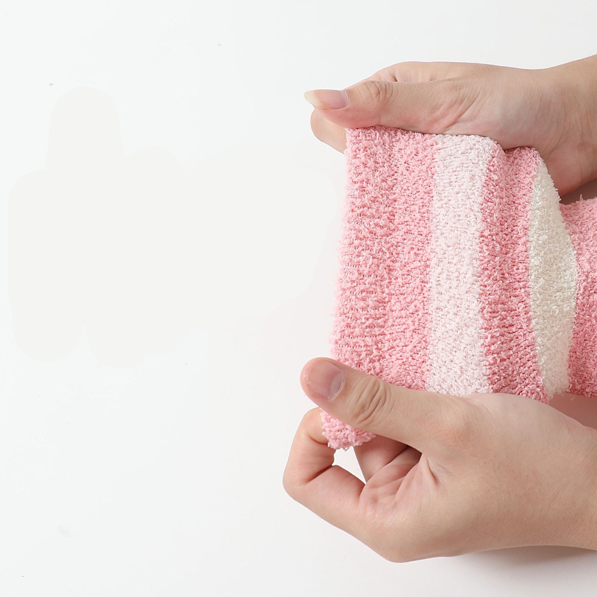 Close-up texture of pink and white striped fuzzy sock material showing plush knit detail
