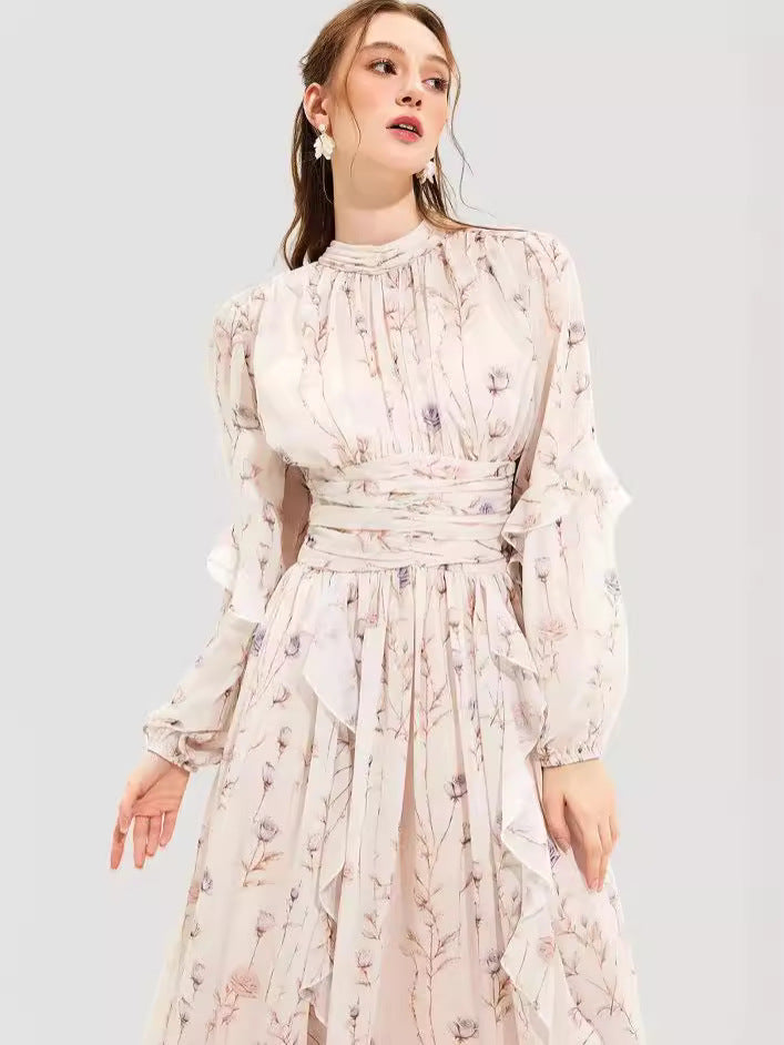 Close-up of a woman wearing a floral maxi dress with ruched detailing, puff sleeves, and ruffle trim, highlighting the soft fabric and intricate design