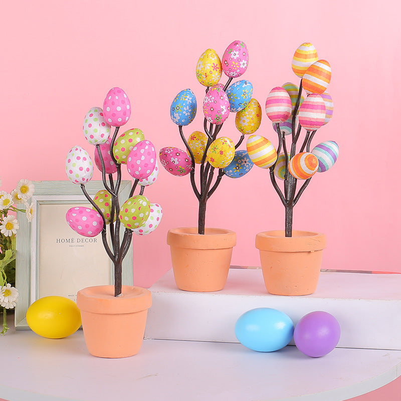 Three mini Easter egg trees with polka dots and stripes in pastel shades, displayed against a pink background for spring decor.