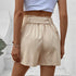 Back view of beige paper bag shorts with elastic waistband and ruffle detail