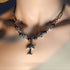 Gothic cross necklace with black beads and silver cross worn on neck