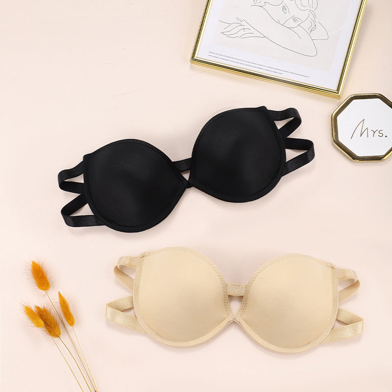 Black and beige strapless bras displayed together with gold-framed sketch and "Mrs." decor