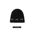 Black knit beanie with three pearl-studded bow decorations, with size measurement (55-60 cm) noted