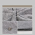 Close-up of gray beanie fabric, showcasing texture and quality construction details