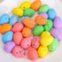 A close-up of multicolored speckled Easter eggs on a white plate, featuring vibrant pastel shades with gold and black speckles.