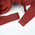 Close-up detail of bra hook closure and strap adjusters in rust color