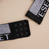 Close-up of black hook-and-eye closure with logo band trim detail