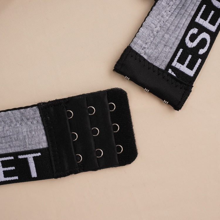 Close-up of black hook-and-eye closure with logo band trim detail