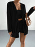 Black ribbed knit lounge set with open cardigan, crop top and shorts, paired with beige handbag and minimal accessories