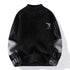 Black mockneck sweater with striped sleeves and deer logo
