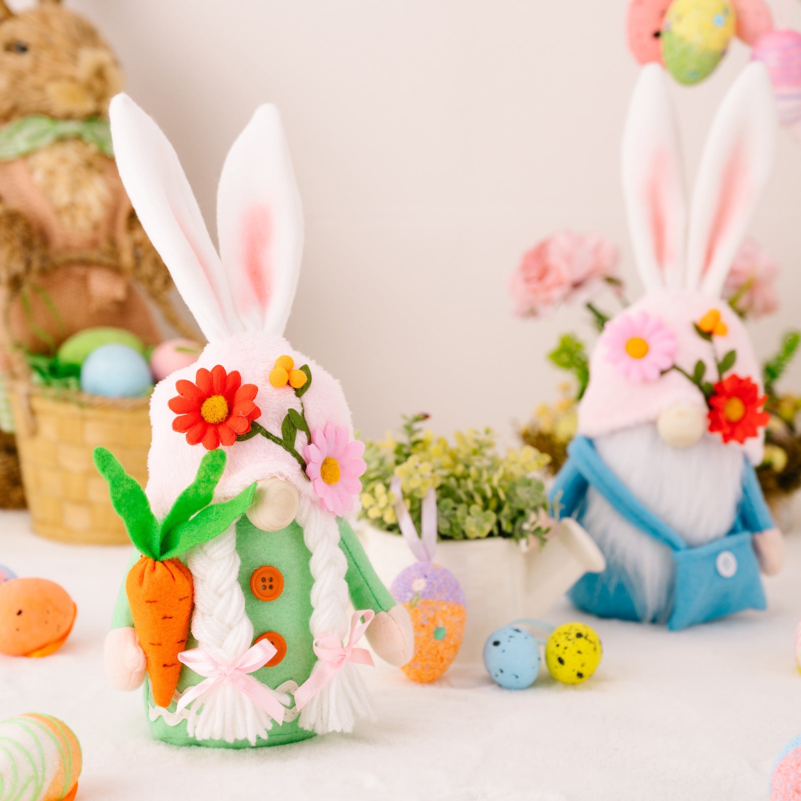 A green-dressed bunny gnome holding a felt carrot, with a braided white beard and floral hat, with pastel Easter eggs and flowers in the background.