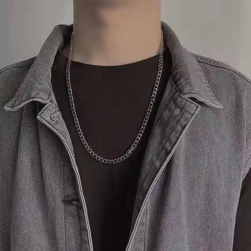 Silver curb chain necklace styled with black t-shirt and grey denim jacket