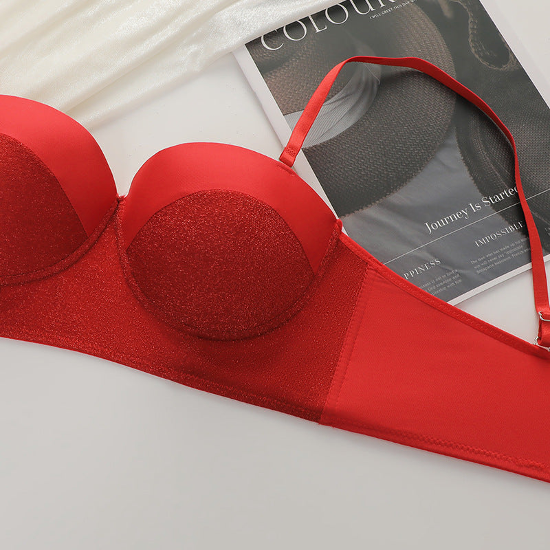 Close-up detail of red glitter bustier bra texture and construction against lifestyle magazine