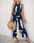 Side view of a navy sleeveless jumpsuit with a belted waist and relaxed fit, featuring white brushstroke detailing