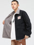Model displaying black denim jacket with gray sherpa lining, white RETRO tee and brown pants. Side view shows patch detail