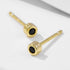 Side angle view of gold-plated stud earrings featuring black nano zirconia stones