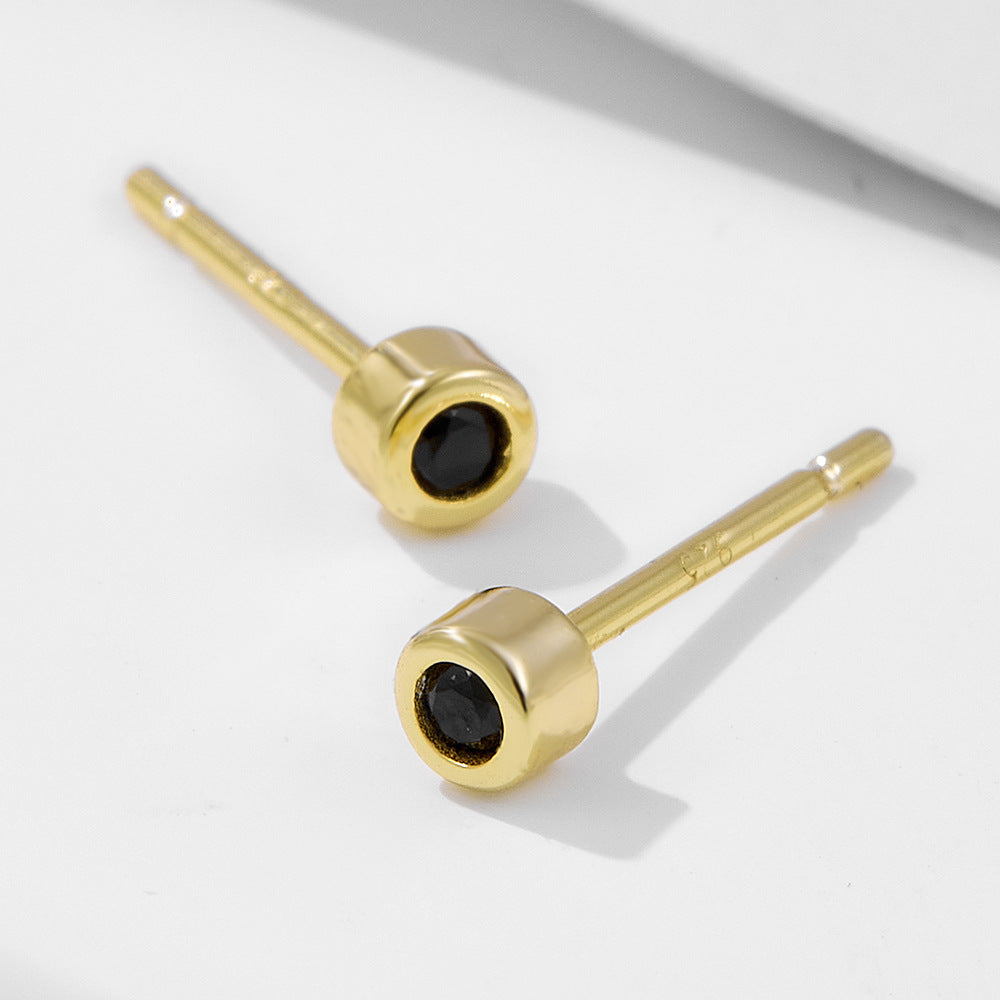 Side angle view of gold-plated stud earrings featuring black nano zirconia stones