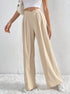 Front view of beige pleated wide-leg trousers styled with white crop top.