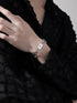 Close-up of a Scorpio zodiac bracelet in stainless steel, featuring a bold charm design, styled with a black outfit.
