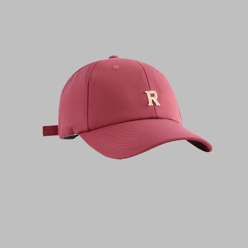Red baseball cap with metallic gold 'R' logo, structured crown and adjustable strap design