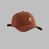Brown baseball cap with metallic gold 'R' logo, structured six-panel design and adjustable strap