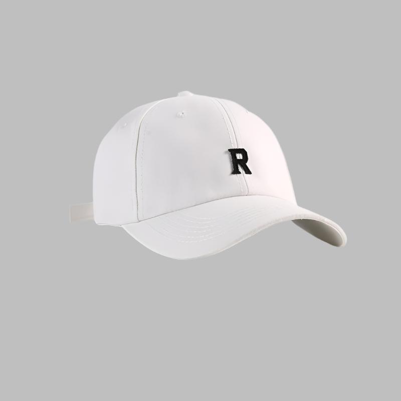 White baseball cap with black 'R' logo embroidery, featuring structured crown and adjustable back strap