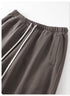 Close-up detail of gray sweatpants fabric showing the soft fleece inner texture and stitched edge