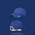 Blue baseball cap front and back views with cream adjustable strap featuring smiley face button on navy background