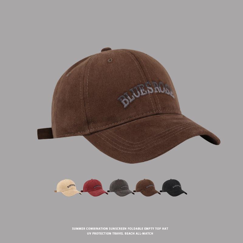 Brown vintage-style baseball cap with 'BluesRose' embroidered logo, curved brim, and adjustable strap