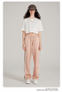 White crop top and pink wide-leg pants with side stripe, white sneakers