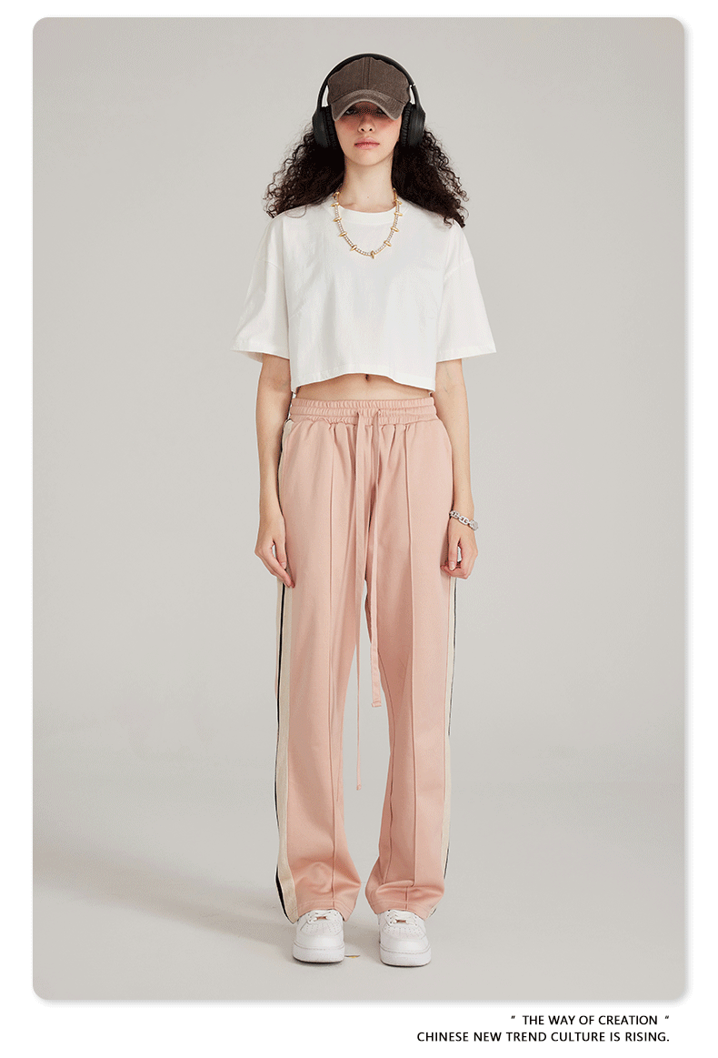 White crop top and pink wide-leg pants with side stripe, white sneakers