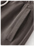 Close-up detail of gray sweatpants pocket with stitching visible against the fabric