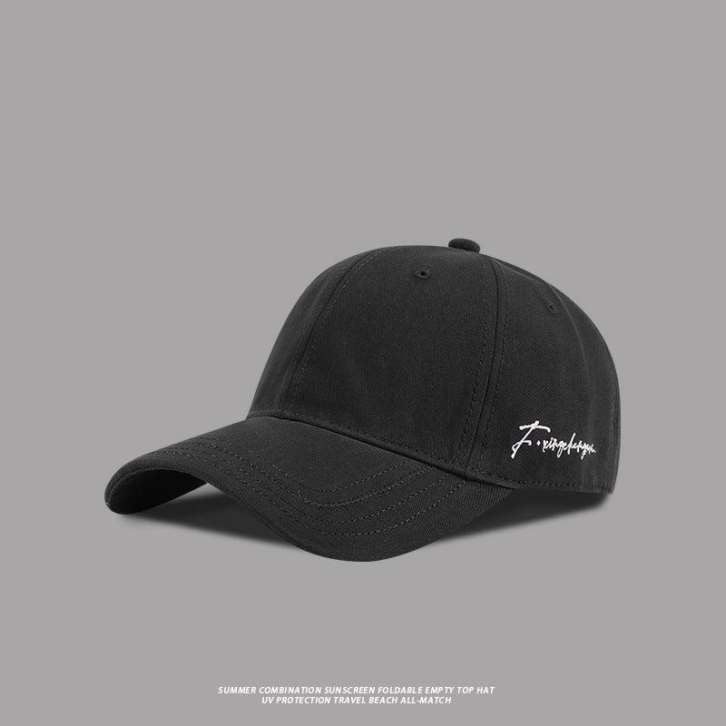 Black baseball cap with white embroidered signature logo, adjustable fit