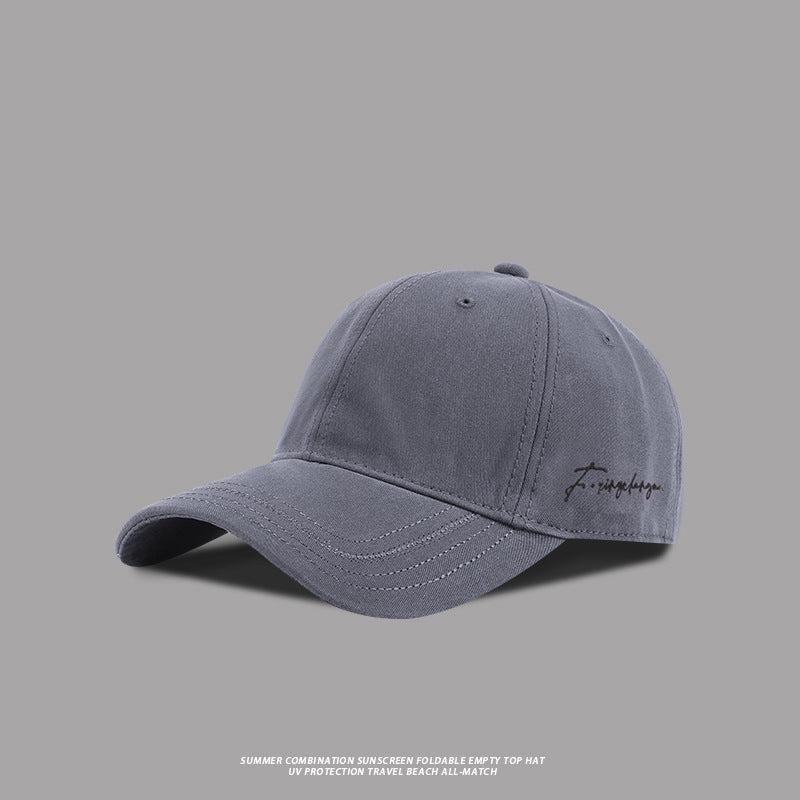 Gray baseball cap with embroidered signature logo, stylish and versatile